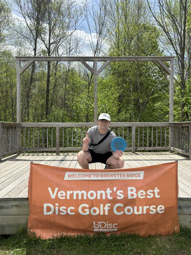 Keith holding a disc at Brewster Ridge disc golf course in Vermont